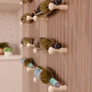 May include: A wall-mounted wine rack with a wooden background. The rack is made of white plastic and features a bone-shaped design. Several bottles of wine are displayed on the rack.