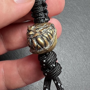 Scary Face Paracord Keychain – Handmade Brass Lanyard Bead with Reflective Braided Cord