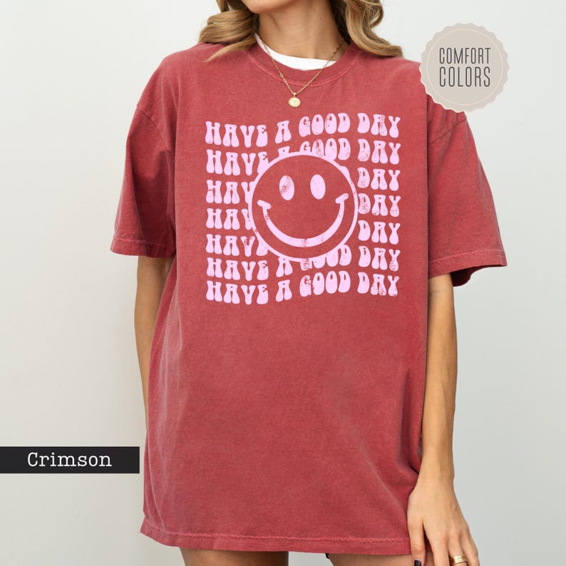 a woman wearing a red shirt that says have a good day have a good day
