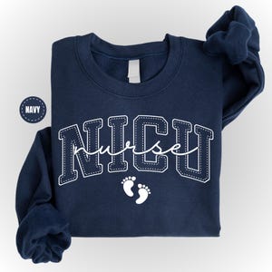 A navy blue sweatshirt with the word "NICU" printed on it, along with a small white footprint symbol.