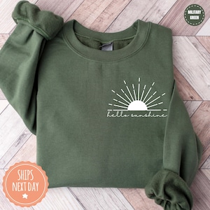 a green sweatshirt with the words hello sunshine on it