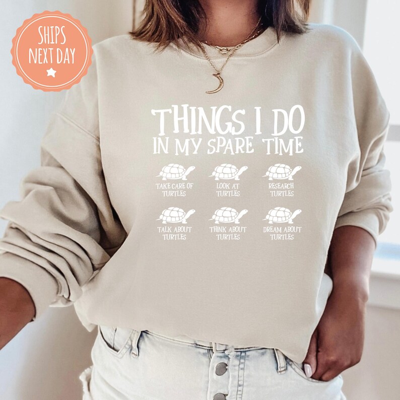 a woman wearing a sweatshirt that says things i do in my spare time