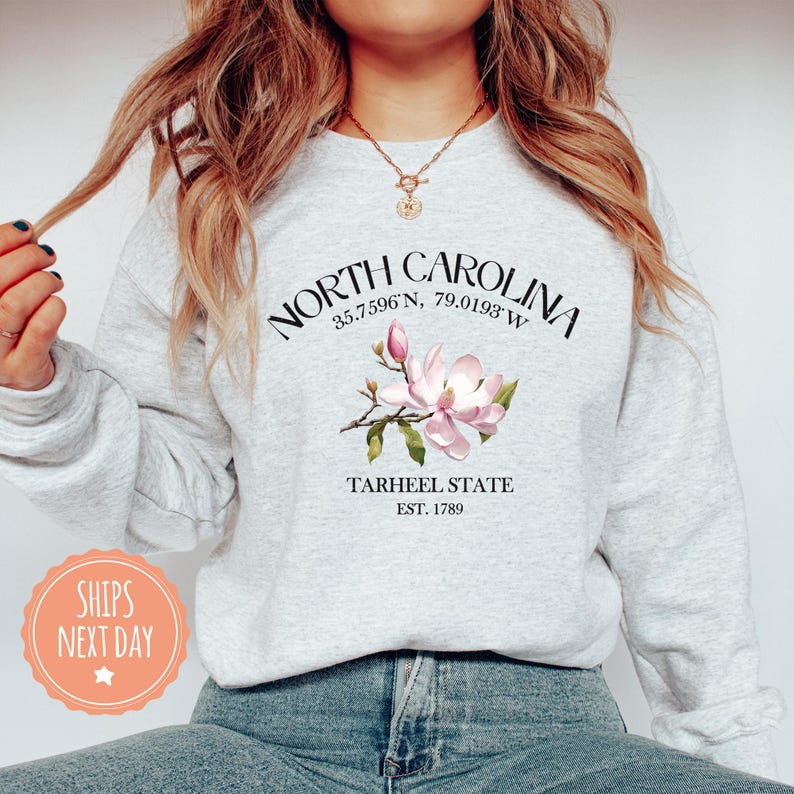a woman wearing a north carolina sweatshirt and jeans
