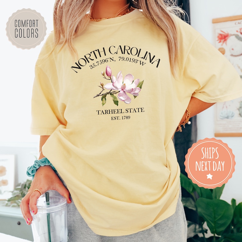 a woman wearing a yellow north carolina t - shirt