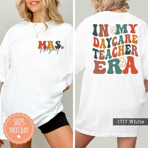 a woman wearing a white tshirt that says in my day care teacher era