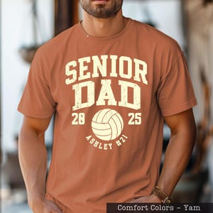 A man wearing a t-shirt with the text "SENIOR DAD" printed on it.