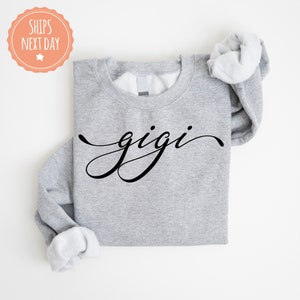 a gray shirt with the word gigi printed on it