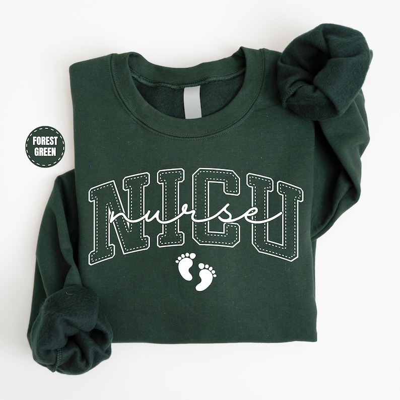 A dark green sweatshirt with the word "NICU" printed on it, along with a pair of white footprints.