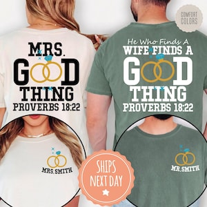 May include: Two t-shirts, one cream and one sage green, featuring back prints with the text "MRS. GOOD THING" and "HE WHO FINDS A WIFE FINDS A GOOD THING" alongside "PROVERBS 18:22" and gold ring graphics. Fronts show small ring icons with "MRS. SMITH" and "MR. SMITH".