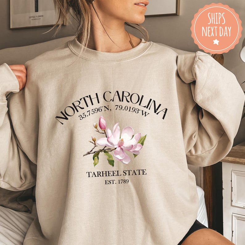 a woman is wearing a north carolina sweatshirt
