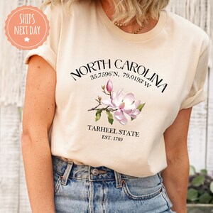 a woman wearing a north carolina t - shirt