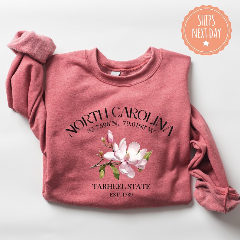a pink shirt with a pink flower on it