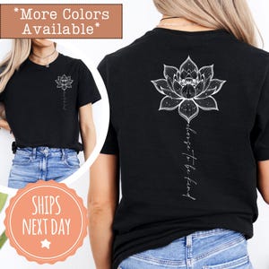 May include: Black t-shirt featuring a white lotus flower design on the back and front. The front of the shirt has a small lotus flower and the words "choose to be kind" are written vertically on the back.