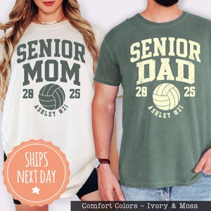 two people wearing t-shirts with the text "SENIOR MOM" and "SENIOR DAD" printed on them, along with a volleyball graphic.