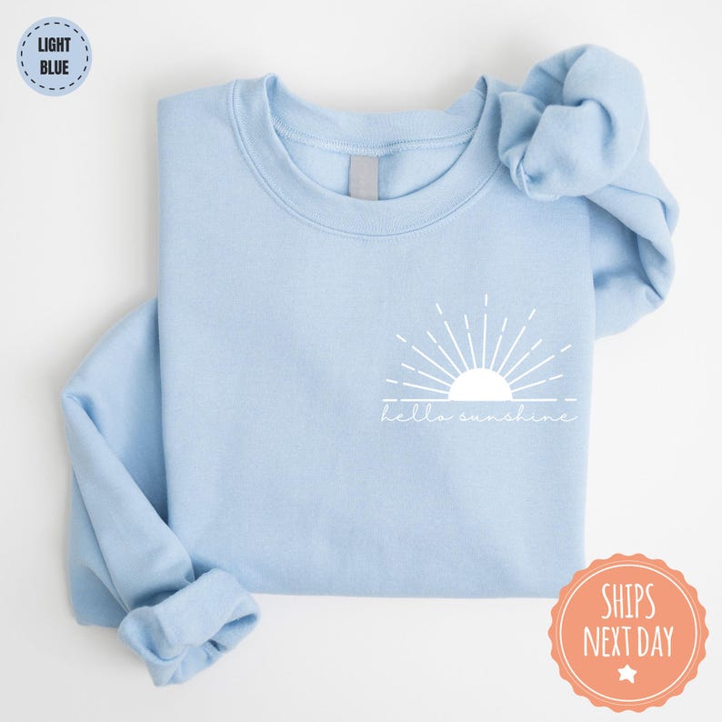 a blue shirt with a white sun on it