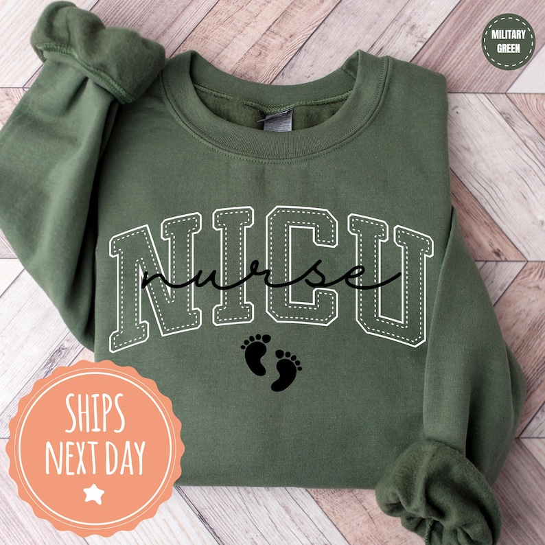 A green sweatshirt with the word "NICU" printed on it, along with a pair of baby feet.