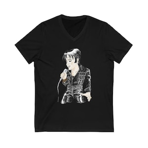 May include: Black V-neck t-shirt with a white illustration of Elvis Presley singing into a microphone.