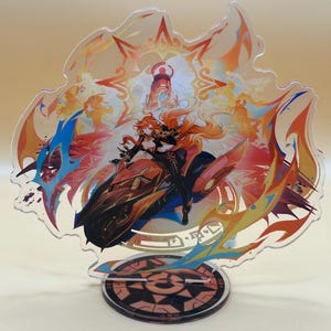May include: A colorful acrylic stand featuring a female anime character riding a motorcycle. The character has long red hair and is wearing a black outfit. The stand is decorated with flames and stars.
