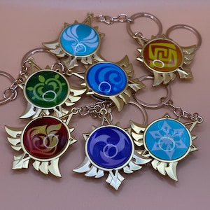 May include: Seven keyrings with gold-coloured metal frames and colourful, circular centre designs. Each keyring features a different symbol in shades of blue, green, red, and yellow. The keyrings are connected to silver-coloured key rings.