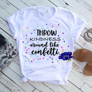 Könnte beinhalten: Weißes T-Shirt mit dem Text "Throw kindness around like confetti" in schwarzer Schrift mit bunten Konfetti, die den Text umgeben.