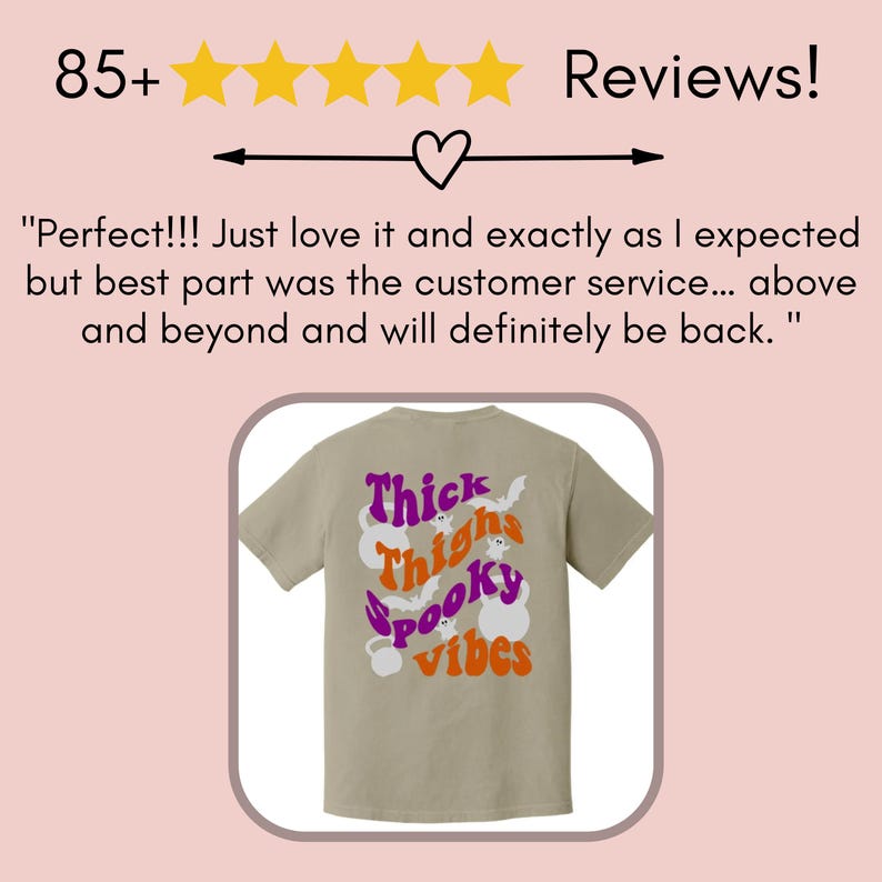 May include: A beige t-shirt with a graphic print on the back. The graphic features the text "Thick Thighs Spooky Vibes" in orange and purple with a ghost and bat design.