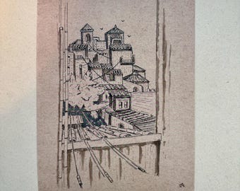 May include: Ink drawing of a cityscape with buildings and rooftops. The artwork is in black ink on a tan paper. The buildings have arched windows and tiled roofs. Power lines are visible in the foreground.
