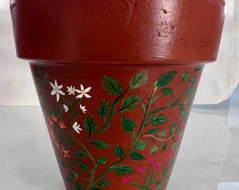 Maceta de terracota con flores pintadas a mano