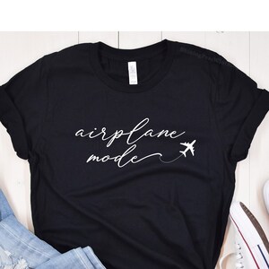 May include: Black t-shirt with white text that says "airplane mode" and a small airplane graphic.