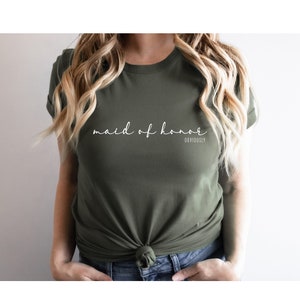 May include: A green t-shirt with the text "maid of honour" in white cursive writing and the word "obviously" in smaller white text below.
