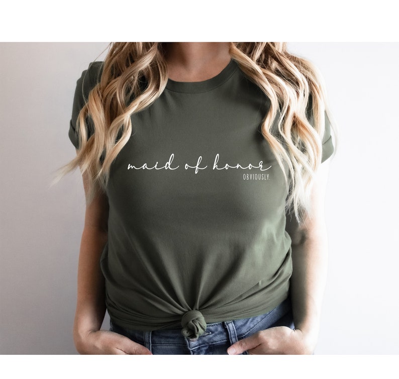 May include: A green t-shirt with the text "maid of honour" in white cursive writing and the word "obviously" in smaller white text below.