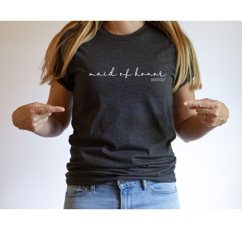 May include: A dark grey t-shirt with the text "maid of honour obviously" in white lettering.