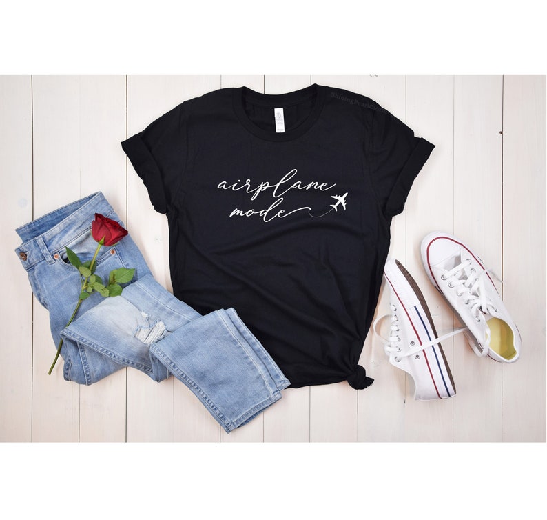 May include: Black t-shirt with white text that says "airplane mode" and a small airplane graphic.