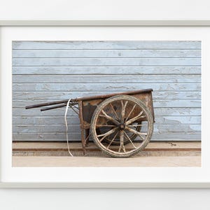 Old homemade metal wheel barrel against a wall in Beijing China | Wall Art