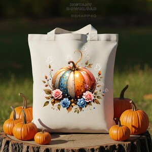 Peut inclure: Un sac fourre-tout crème avec un motif de citrouille colorée, avec des sections roses, oranges et bleues, entouré de fleurs et de papillons. Plusieurs citrouilles oranges de différentes tailles sont disposées autour du sac. Le texte sur le sac indique "INSTANT DOWNLOAD BEHAPP40".