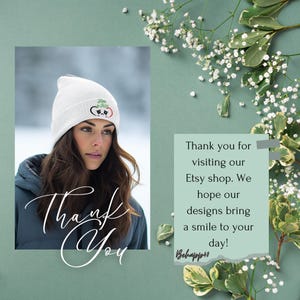 A woman wearing a white beanie and a blue jacket is shown in the image, with a green background and white flowers. The image also contains a message expressing gratitude for the woman's visit to the Etsy shop and her designs bringing a smile to the day.