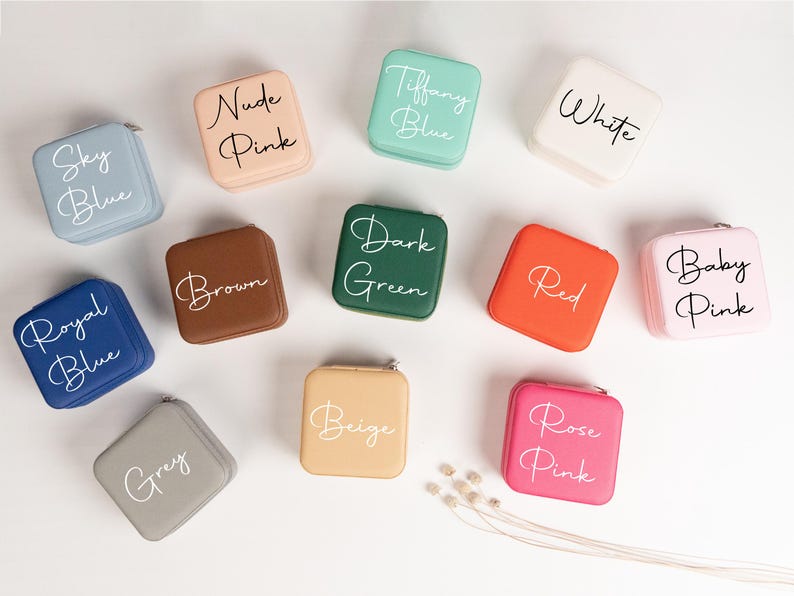 May include: Twelve small square boxes in various colors with white lettering. The boxes are labeled with colors such as Sky Blue, Nude Pink, Tiffany Blue, White, Dark Green, Red, Royal Blue, Brown, Grey, Beige, Rose Pink, and Baby Pink.