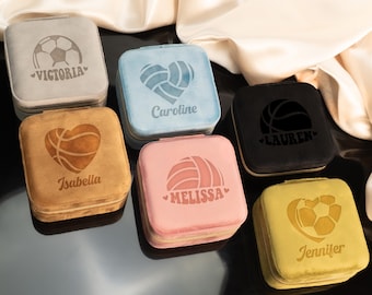 May include: Six velvet jewelry boxes with different sports-themed designs. Each box has a different name and a different sport: soccer, volleyball, basketball, soccer, volleyball, and soccer. The boxes are all in different colors: gray, blue, brown, pink, black, and yellow.