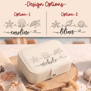 May include: A rectangular cream-colored jewelry box with a snap closure, featuring a black line art engraving of a starfish, a seashell, a sea turtle, and the name nichole. Above, two design options show variations of sea-themed graphics.