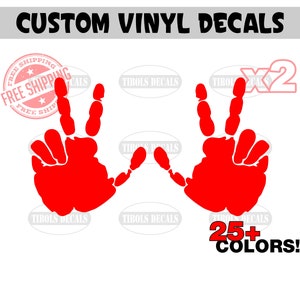 May include: Two red handprint vinyl decals with peace signs. The decals are available in 25+ colors.  "CUSTOM VINYL DECALS" and "FREE SHIPPING" are written in the image.