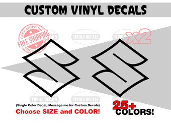 May include: Two black vinyl decals featuring the Suzuki logo, displayed against a light gray background. The text CUSTOM VINYL DECALS appears at the top, with additional text including 25+ COLORS, X2, and Choose SIZE and COLOR visible.