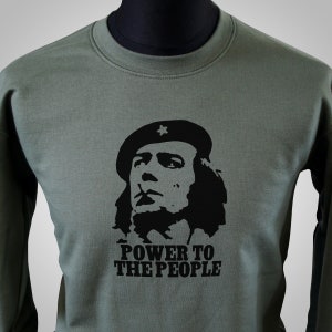 May include: Green long-sleeved sweatshirt featuring a black and white image of a person wearing a beret with a star on it. The text "POWER TO THE PEOPLE" is printed below the image.