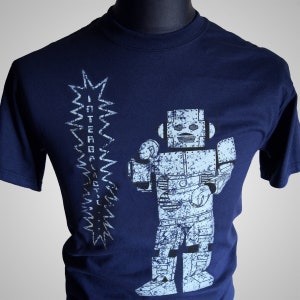 May include: A navy blue t-shirt with a white robot graphic and the text "INTERGALACTIC" in a stylized font.