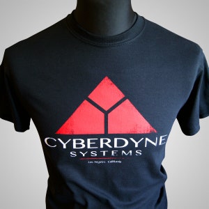 May include: Black t-shirt with a red triangle logo and the text "CYBERDYNE SYSTEMS Los Angeles, California".