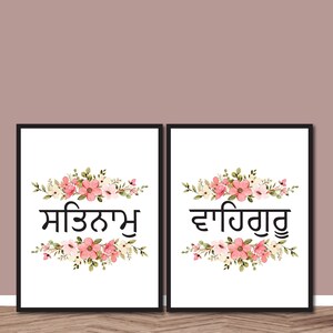 May include: Two framed art prints with black text and floral arrangements. The text is in a script font, with each print featuring a different phrase. The floral arrangements include pink and white flowers with green leaves.