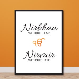 May include: Black framed print with white background and black text. The text reads "Nirbhau" without fear and "Nirvair" without hate. A gold symbol is in the middle of the print.