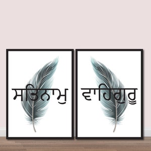 May include: Two framed prints with a white background and a single gray feather in each. The text "ਸਤਿਨਾਮ" is printed below the feather on the left print and "ਵਾਹਿਗੁਰੂ" is printed below the feather on the right print.