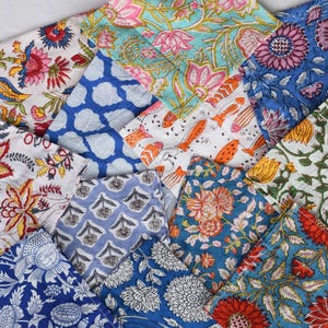 May include: A collection of 12 colorful fabric squares with floral and geometric patterns. The squares are made of cotton and are perfect for quilting, crafts, or home decor.