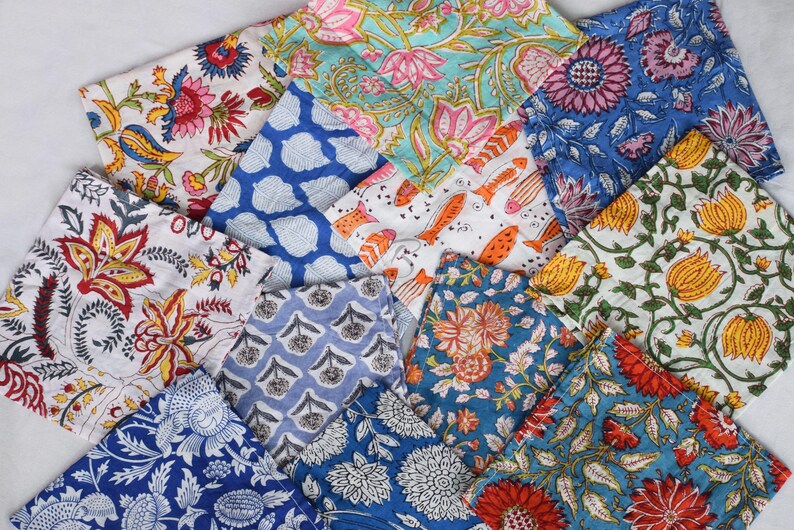 May include: A collection of 12 colorful fabric squares with floral and geometric patterns. The squares are made of cotton and are perfect for quilting, crafts, or home decor.