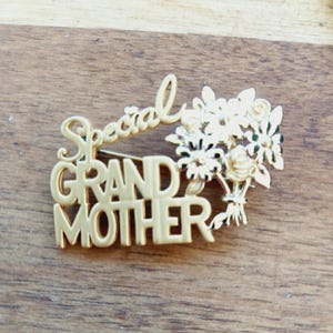 May include: Gold-toned brooch with the words "Special Grandmother" and a bouquet of flowers.