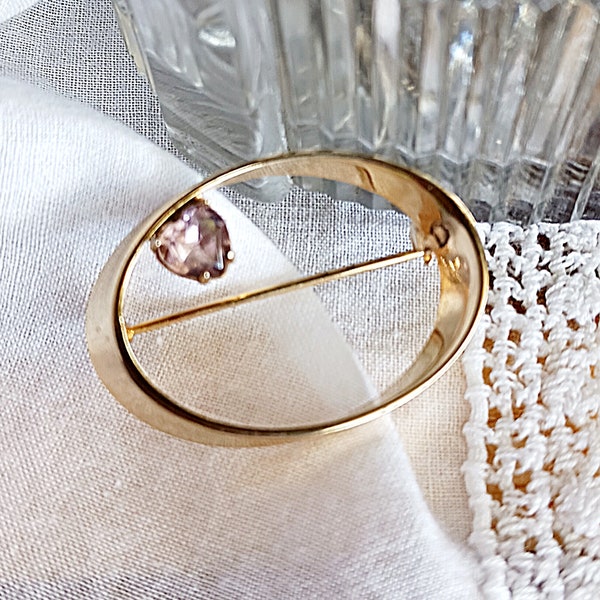 Vintage gold tone oval slanted brooch with lavender heart shaped crystal, small elliptical accent pin faux amethyst, understated jewelry